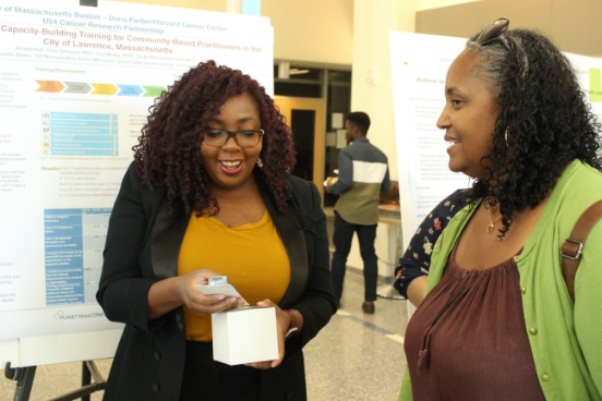 Photo of Director of Outreach Core, Tiffany Donaldson, PhD, talking to student