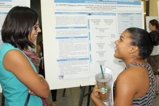 Photo of Outreach Core Director, Shoba Ramanadhan, looking at scientific poster with student